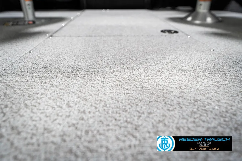 Slide: The Image of 2025 Lund 1875 Tyee boat interior flooring, textured surface, Reeder-Trausch logo visible. - 49