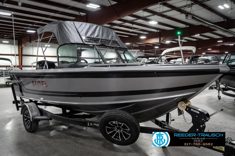 Slide: The Image of 2025 Lund 1875 Tyee boat displayed indoors on a trailer. - 6