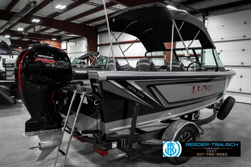 Slide: The Image of 2025 Lund 1875 Tyee boat with Mercury engine in showroom setting. - 8