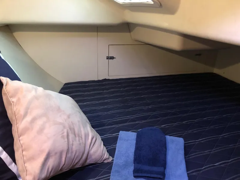 Slide: The Image of Cozy cabin interior of 2008 Hunter 31 sailboat with pillows and towels. - 10