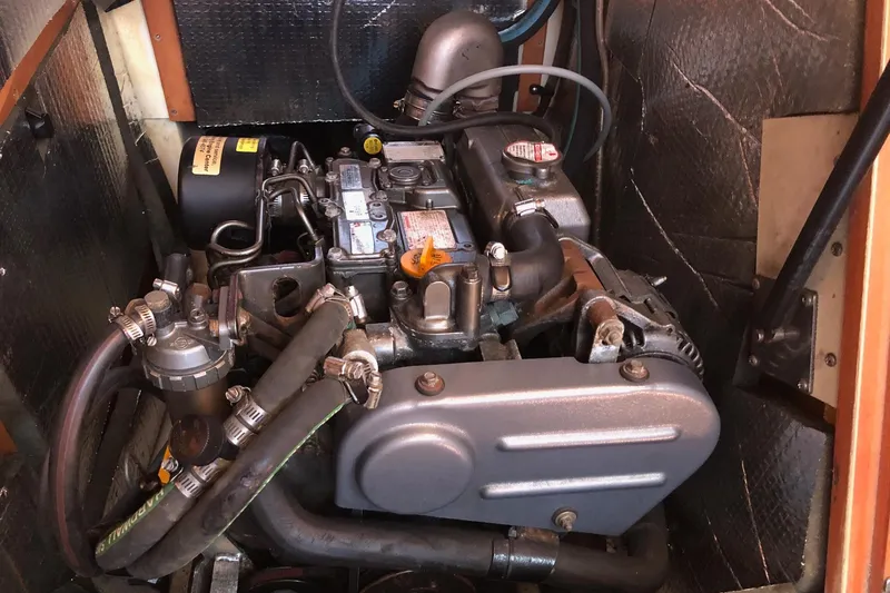 Slide: The Image of Engine compartment of a 2008 Hunter 31 sailboat, showcasing mechanical components and hoses. - 11