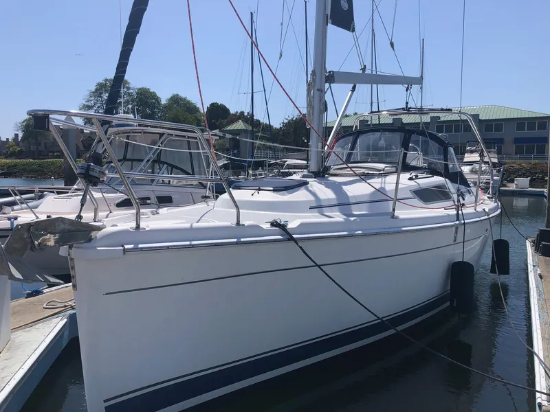 Slide: The Image of 2008 Hunter 31 sailboat docked in marina, featuring sleek white hull and modern design. - 12