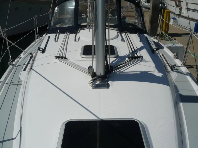 Slide: The Image of 2008 Hunter 31 sailboat deck with rigging and hatch, docked at marina. - 13