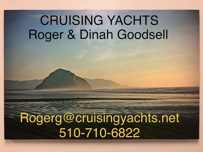 Slide: The Image of Cruising Yachts advertisement with contact details over a scenic beach sunset. - 22