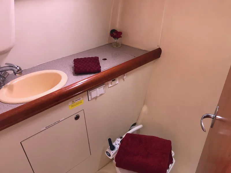 Slide: The Image of Compact bathroom in 2008 Hunter 31 yacht with sink and red towels. - 8