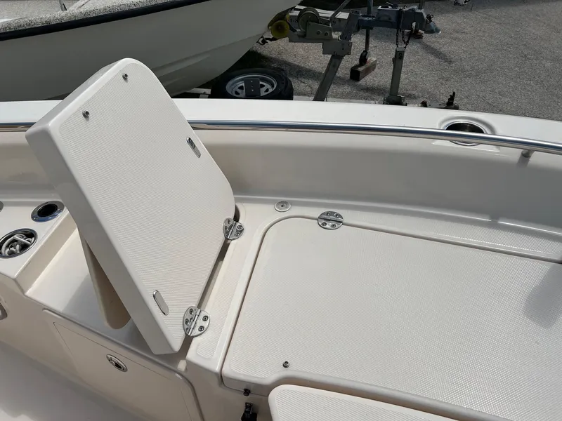 Slide: The Image of 2014 Grady-White 251 Coastal Explorer boat seating area with storage compartment. - 11