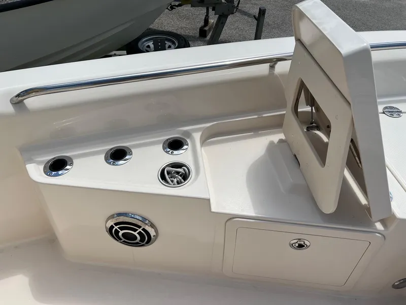 Slide: The Image of 2014 Grady-White 251 Coastal Explorer boat interior with cup holders and storage compartment. - 12