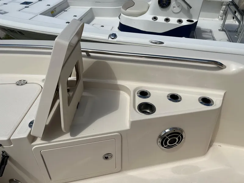 Slide: The Image of 2014 Grady-White 251 Coastal Explorer boat interior with cup holders and storage compartment. - 13