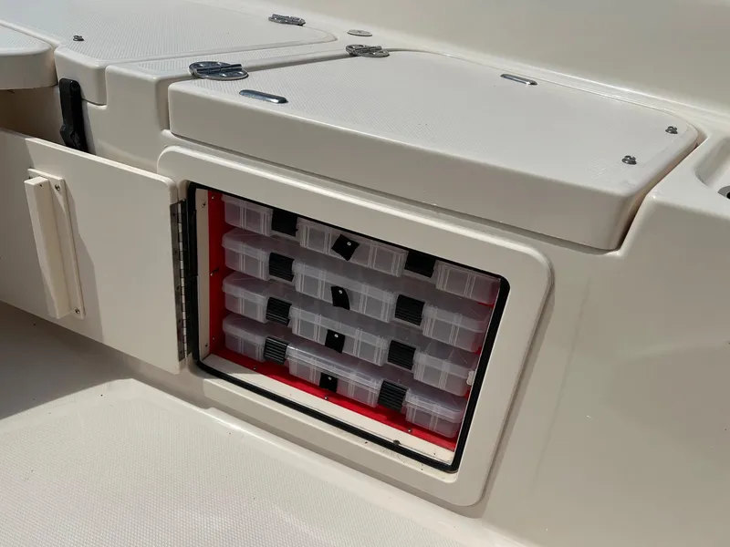 Slide: The Image of Storage compartment with tackle boxes on a 2014 Grady-White 251 Coastal Explorer boat. - 14