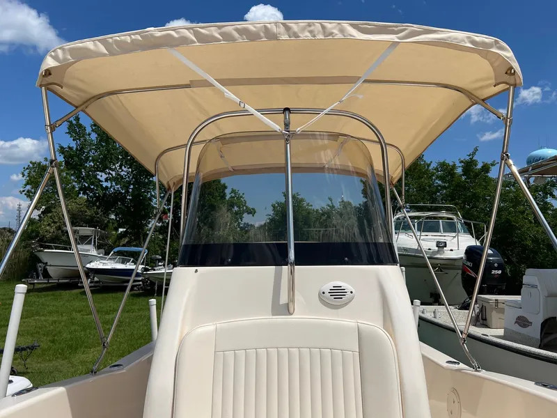 Slide: The Image of 2014 Grady-White 251 Coastal Explorer boat with canopy, parked outdoors. - 16