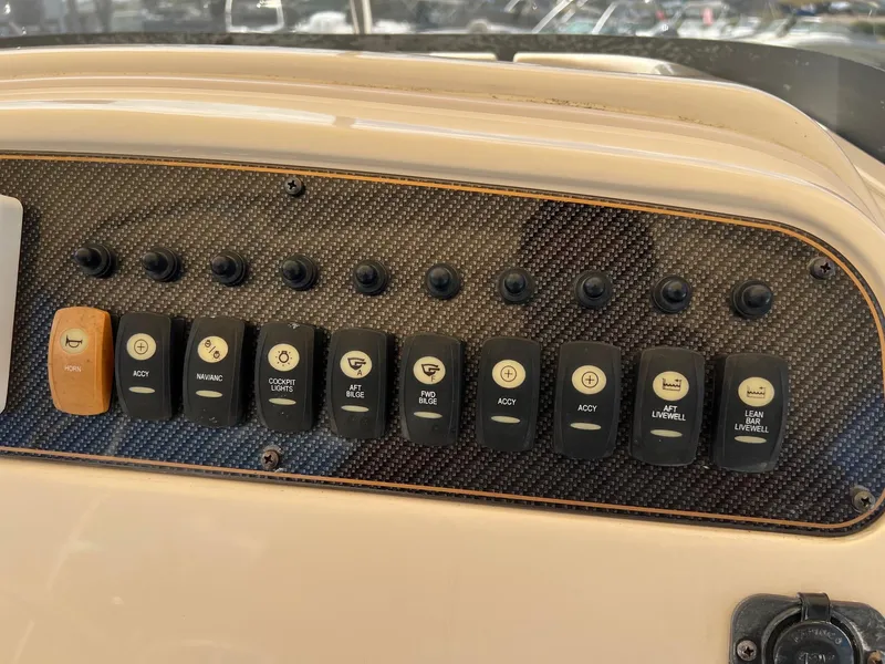 Slide: The Image of Control panel of 2014 Grady-White 251 Coastal Explorer boat with labeled switches. - 23