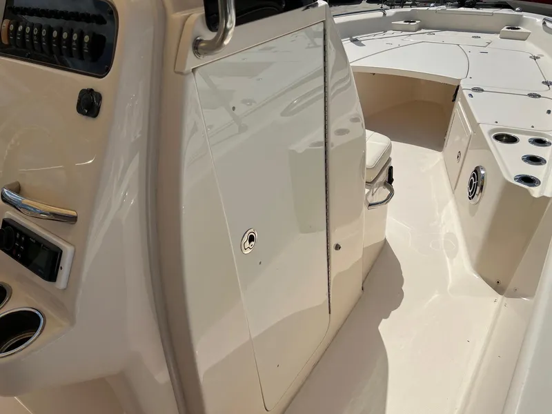 Slide: The Image of 2014 Grady-White 251 Coastal Explorer boat interior with console and seating area. - 26
