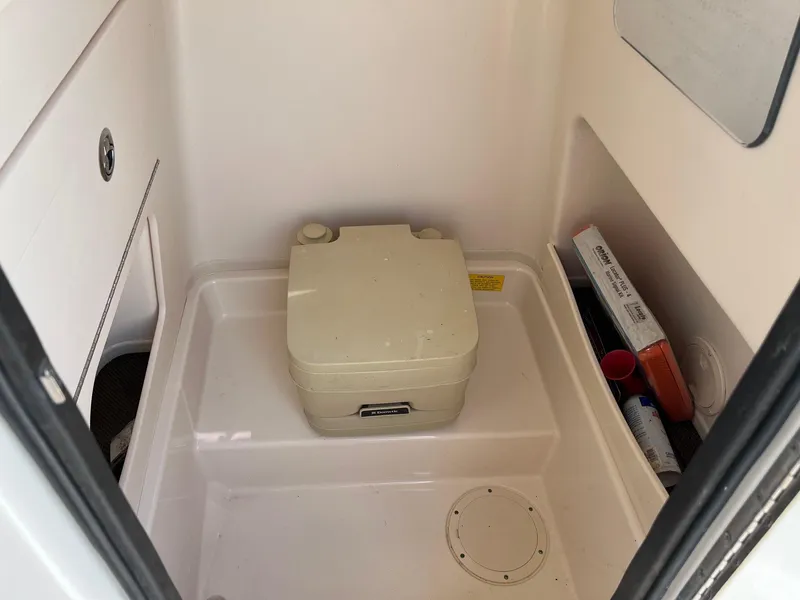 Slide: The Image of 2014 Grady-White 251 Coastal Explorer boat interior with portable toilet. - 28