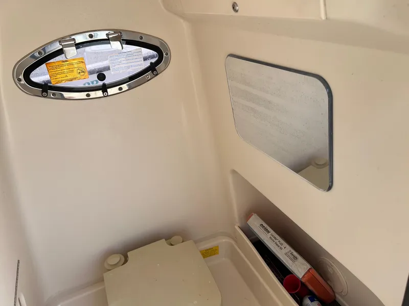 Slide: The Image of 2014 Grady-White 251 Coastal Explorer cabin interior with porthole and storage area. - 29
