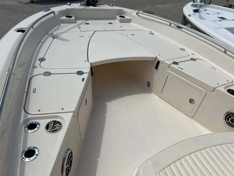 Slide: The Image of 2014 Grady-White 251 Coastal Explorer boat interior with storage compartments and seating. - 3
