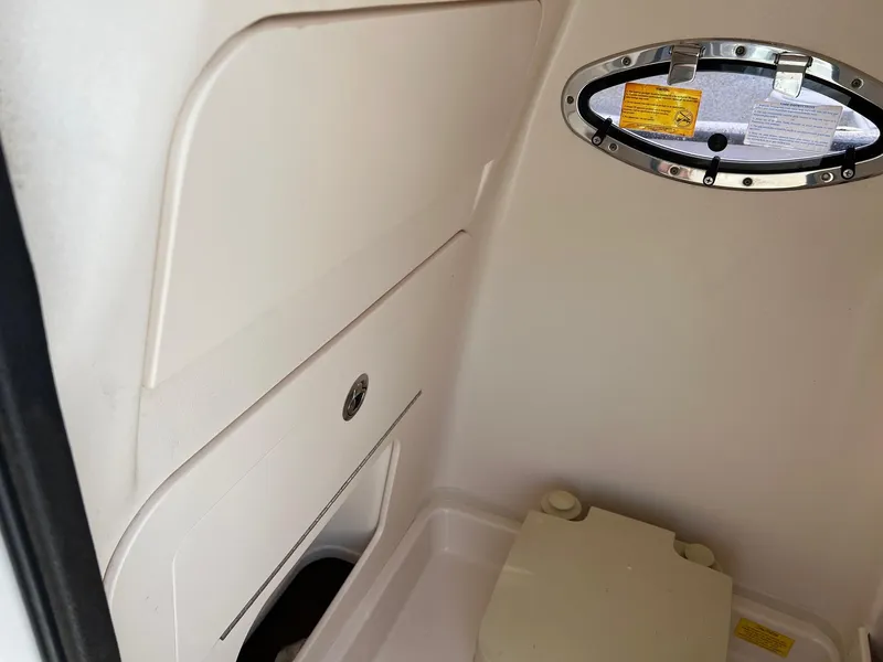 Slide: The Image of Interior cabin of 2014 Grady-White 251 Coastal Explorer boat with porthole and storage. - 30