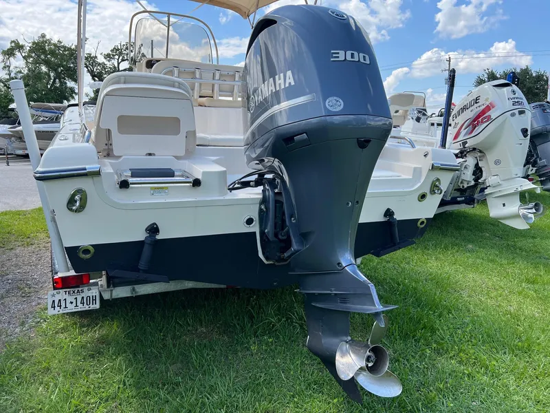 Slide: The Image of 2014 Grady-White 251 Coastal Explorer boat with Yamaha 300 outboard motor, parked on grass. - 36