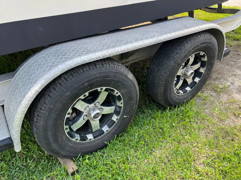 Slide: The Image of Trailer wheels of a 2014 Grady-White 251 Coastal Explorer on grass. - 37