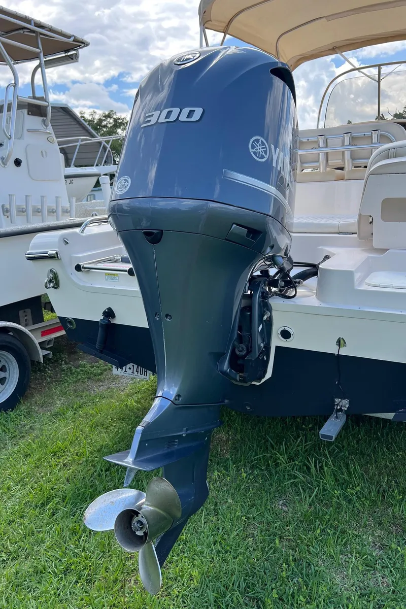 Slide: The Image of 2014 Grady-White 251 Coastal Explorer with Yamaha 300 outboard engine, parked on grass. - 42