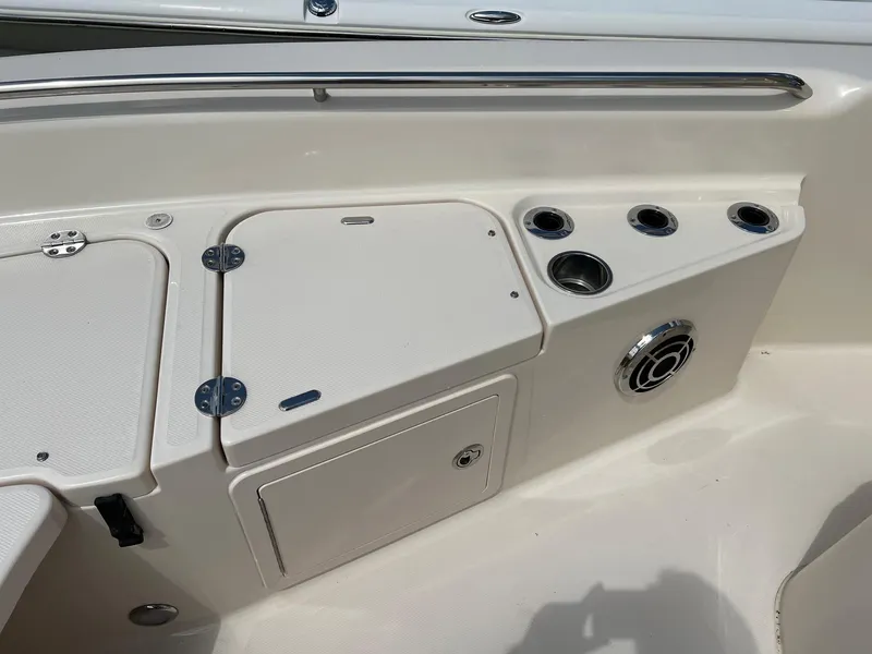 Slide: The Image of 2014 Grady-White 251 Coastal Explorer boat interior with storage compartments and cup holders. - 5