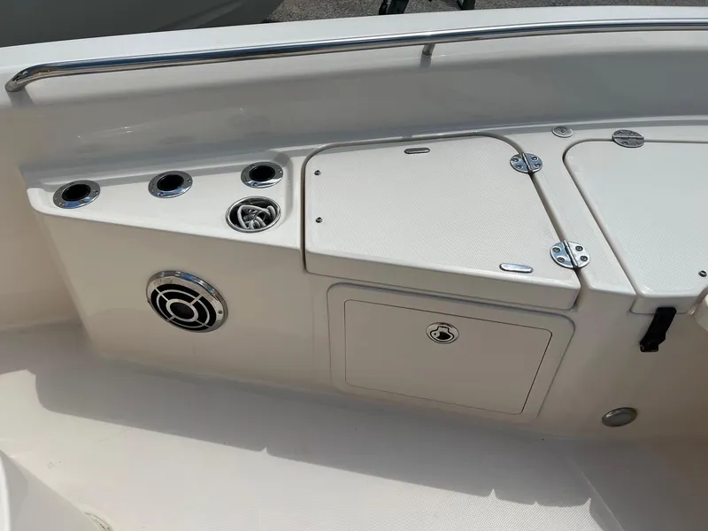 Slide: The Image of 2014 Grady-White 251 Coastal Explorer boat interior with storage compartments and cup holders. - 6