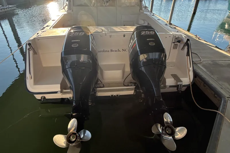 Slide: The Image of 2002 Grady-White Express 330 boat with twin 250 horsepower outboard engines docked. - 11