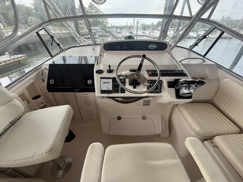 Slide: The Image of 2002 Grady-White Express 330 helm with steering wheel and navigation controls. - 15