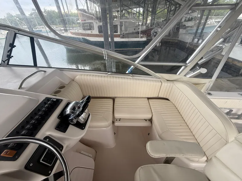Slide: The Image of 2002 Grady-White Express 330 boat interior with helm and seating area. - 17