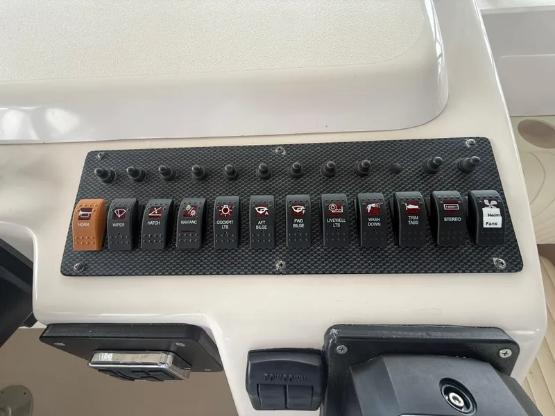 Slide: The Image of Control panel of a 2002 Grady-White Express 330 boat with labeled switches. - 18