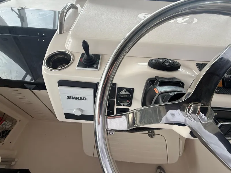 Slide: The Image of Helm of 2002 Grady-White Express 330 with Simrad navigation system and steering wheel. - 19