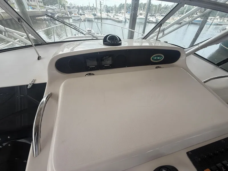 Slide: The Image of 2002 Grady-White Express 330 helm with compass, docked at marina. - 22