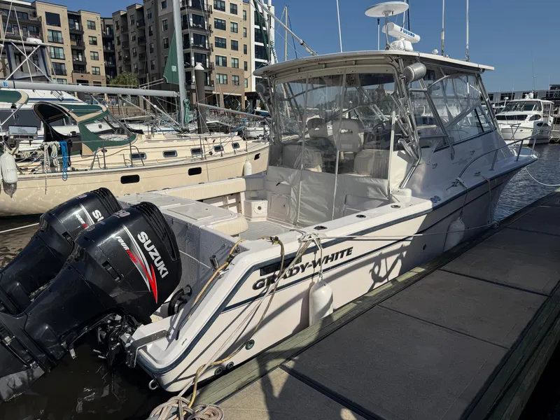 Slide: The Image of 2002 Grady-White Express 330 boat docked with twin Suzuki outboard motors. - 28