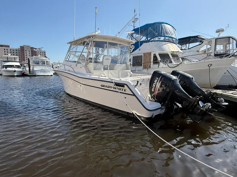 Slide: The Image of 2002 Grady-White Express 330 boat docked with twin outboard engines. - 33