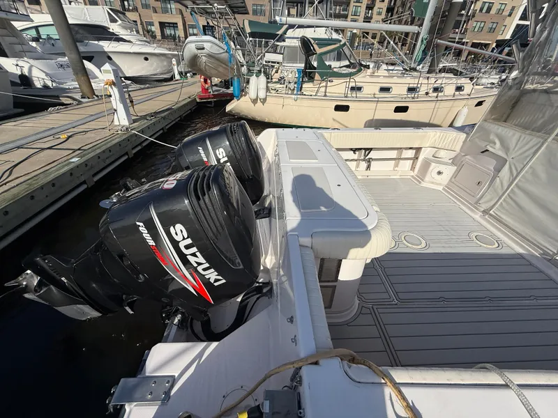 Slide: The Image of 2002 Grady-White Express 330 boat with Suzuki outboard motors docked at marina. - 35
