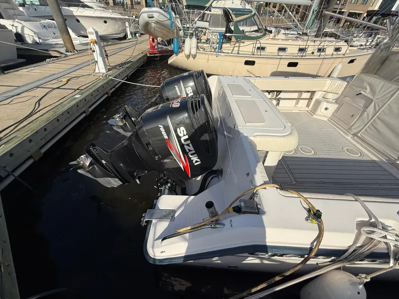 Slide: The Image of 2002 Grady-White Express 330 with twin Suzuki outboard motors docked at marina. - 36