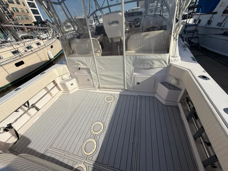 Slide: The Image of 2002 Grady-White Express 330 boat deck with seating and helm, docked at marina. - 38