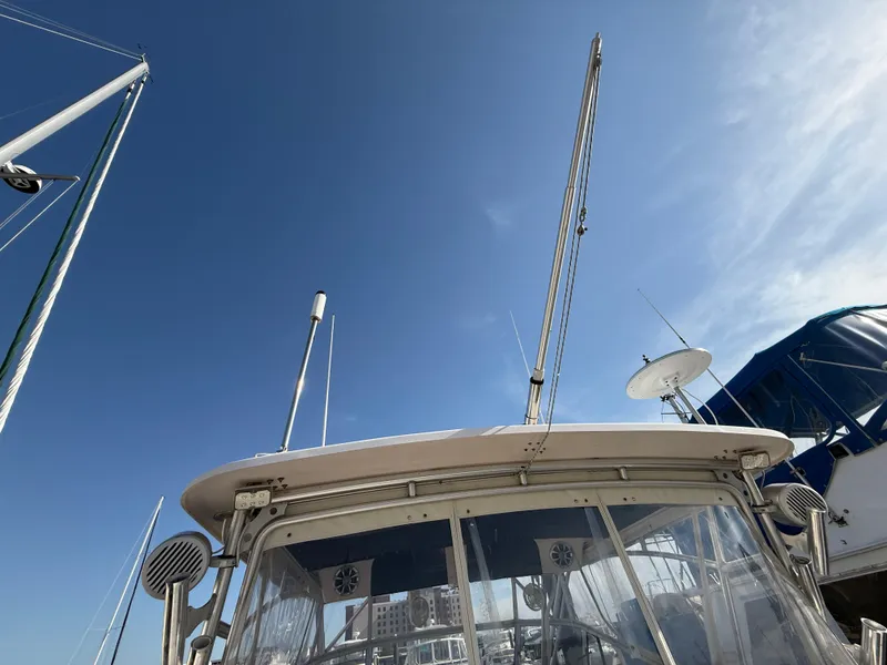 Slide: The Image of 2002 Grady-White Express 330 boat with antennas against a clear blue sky. - 43