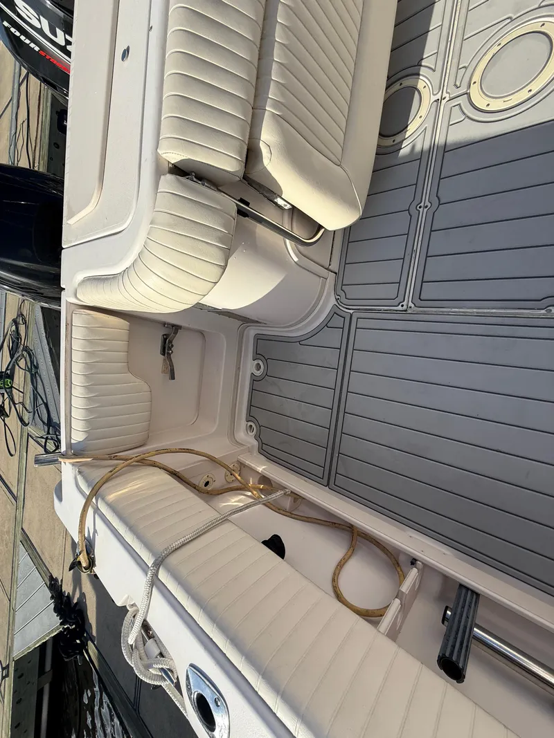 Slide: The Image of 2002 Grady-White Express 330 boat interior with cushioned seating and gray deck flooring. - 46