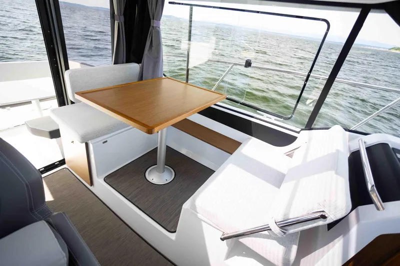 Slide: The Image of Interior of 2022 Jeanneau NC Weekender 895 with dining area and sea view. - 12