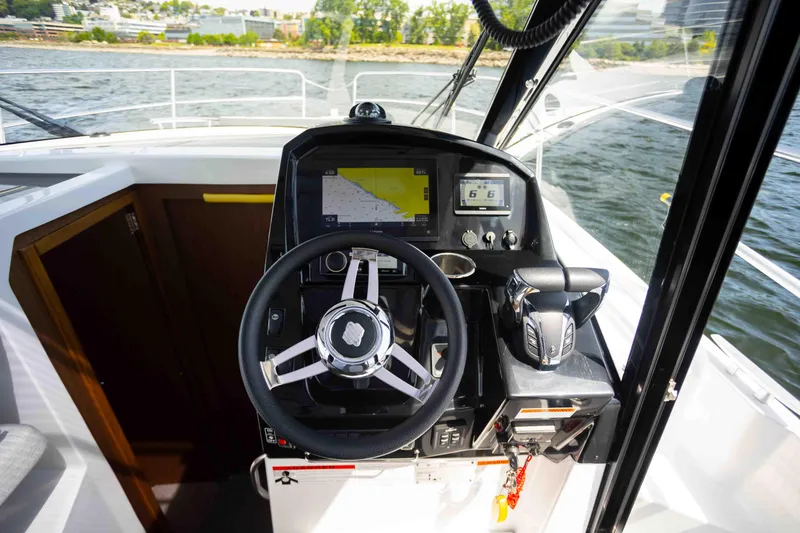 Slide: The Image of Cockpit of 2022 Jeanneau NC Weekender 895 with steering wheel and navigation controls. - 15