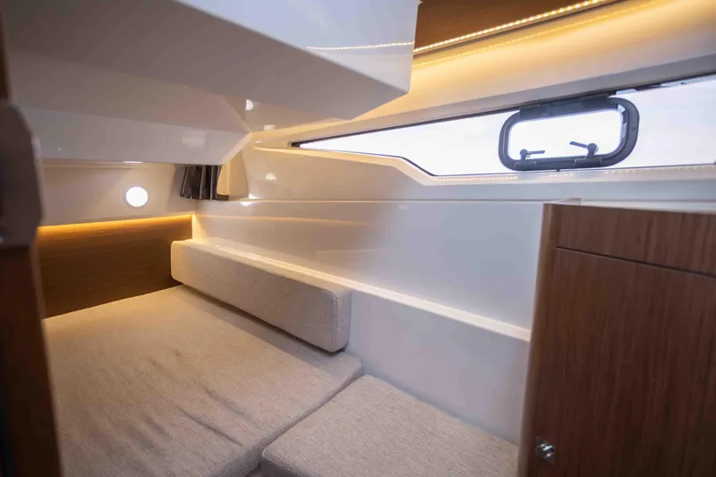 Slide: The Image of Interior cabin of 2022 Jeanneau NC Weekender 895, featuring cozy seating and modern design. - 16