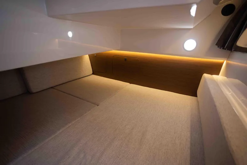 Slide: The Image of Interior cabin of 2022 Jeanneau NC Weekender 895 with cozy lighting and comfortable seating. - 17