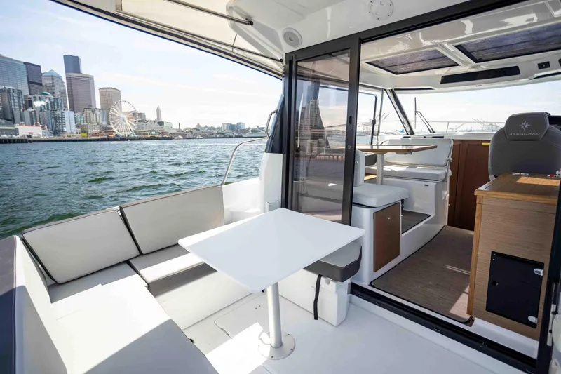 Slide: The Image of 2022 Jeanneau NC Weekender 895 boat interior with city skyline view. - 6