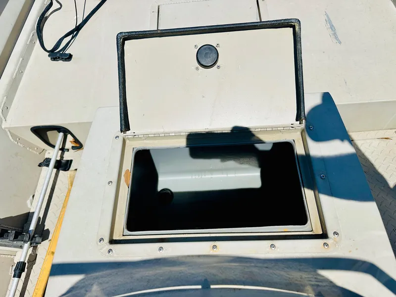 Slide: The Image of 2008 SeaArk x160 boat storage compartment with open hatch, showing interior space. - 12