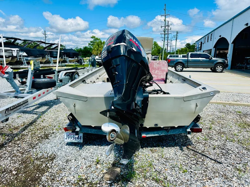 Slide: The Image of 2008 SeaArk x160 boat with outboard motor on trailer, parked outdoors. - 3
