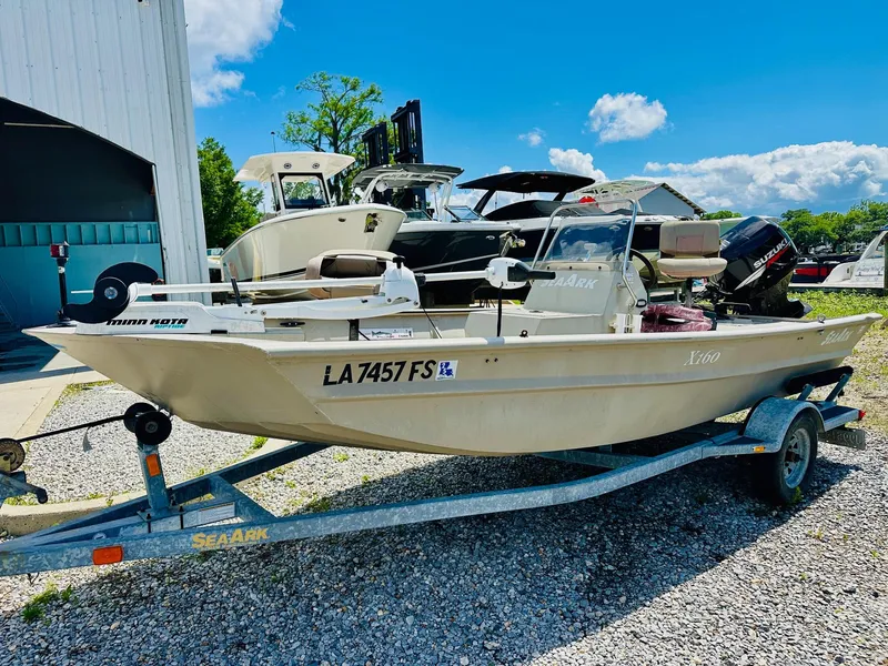 Slide: The Image of 2008 SeaArk x160 boat on trailer, parked outdoors under a clear blue sky. - 5