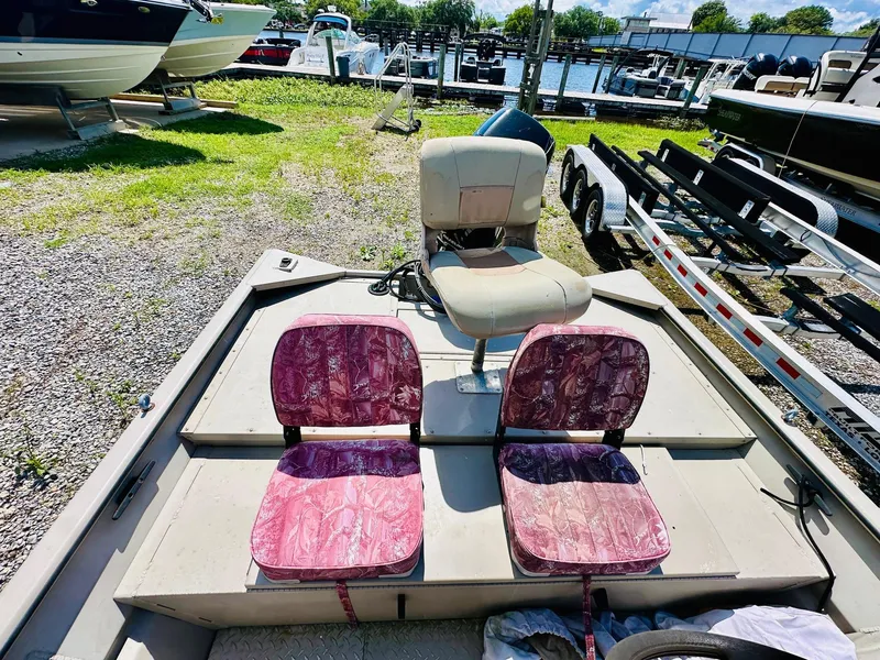 Slide: The Image of 2008 SeaArk x160 boat with three seats, parked near a marina. - 9