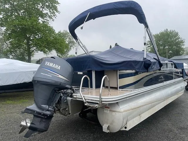 Slide: The Image of 2011 Bennington 2275GLi pontoon boat with Yamaha outboard motor, covered and parked outdoors. - 3