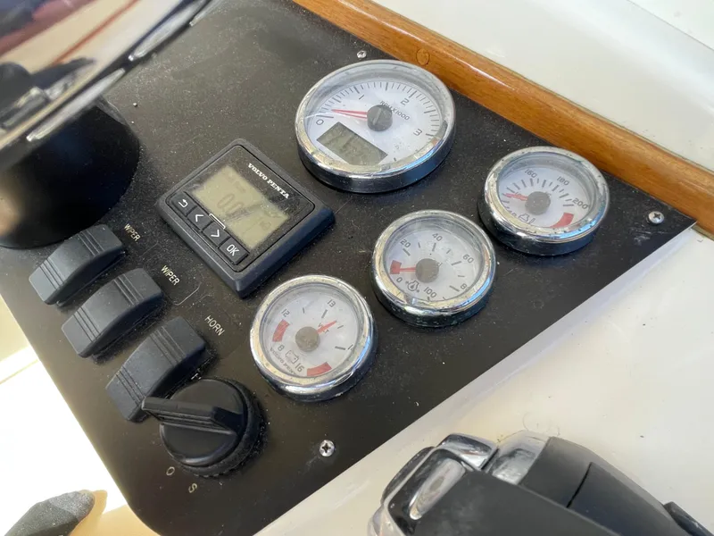 Slide: The Image of Control panel of a 2015 Fortier 30 boat with gauges and switches. - 14