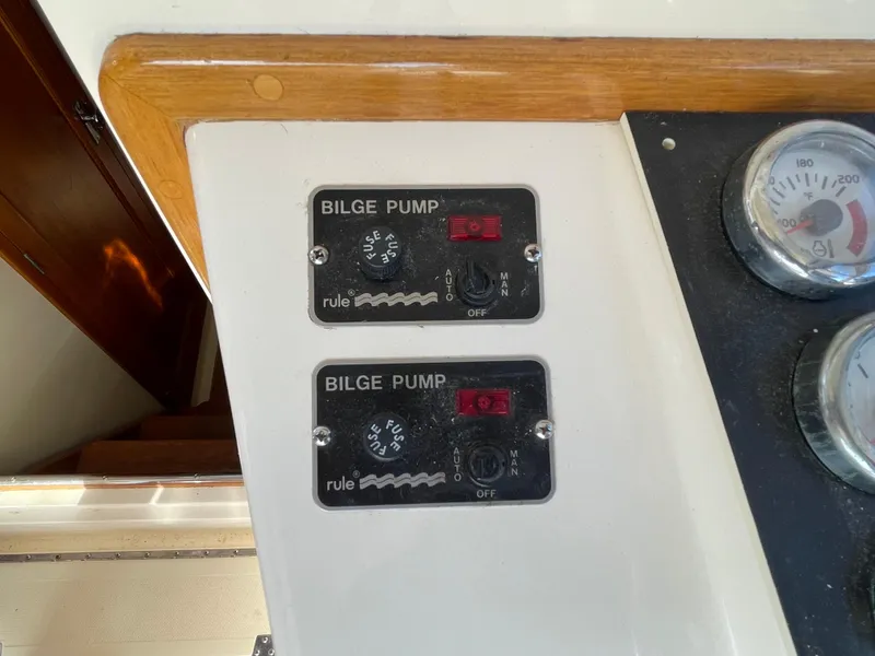 Slide: The Image of Control panel with bilge pump switches on a 2015 Fortier 30 boat. - 16